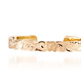 The picture shows a 14K yellow gold hand-engraved bangle sea turtle design with cut-out edges.