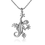 In this photo there is a white gold gecko pendant.