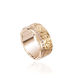 The picture shows a 14K yellow gold diamond Channel 8 mm ring with hand-engravings, including a sea turtle.