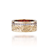 The picture shows a 14K yellow gold diamond Channel 8 mm ring with hand-engravings, including a sea turtle.