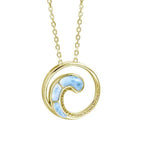In this photo there is a yellow gold circle pendant with a wave and blue larimar gemstones.