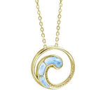 In this photo there is a yellow gold circle pendant with a wave and blue larimar gemstones.