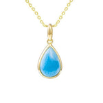 The photo shows a 14K yellow gold larimar teardrop pendant.