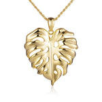In this photo there is a yellow gold monstera pendant.