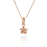 In this photo there is a rose gold plumeria pendant with hand engravings.