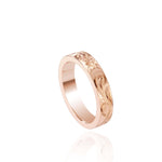 In this photo there is a rose gold ring with flower and scroll hand engravings.
