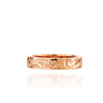 In this photo there is a rose gold ring with flower and scroll hand engravings.
