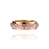 The picture shows a 14K yellow and rose gold two-tone infinity ring with diamonds and hand-engravings.