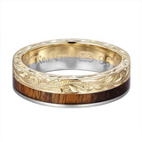 In this photo there is a white and yellow gold two-tone koa wood ring with scroll hand engravings.