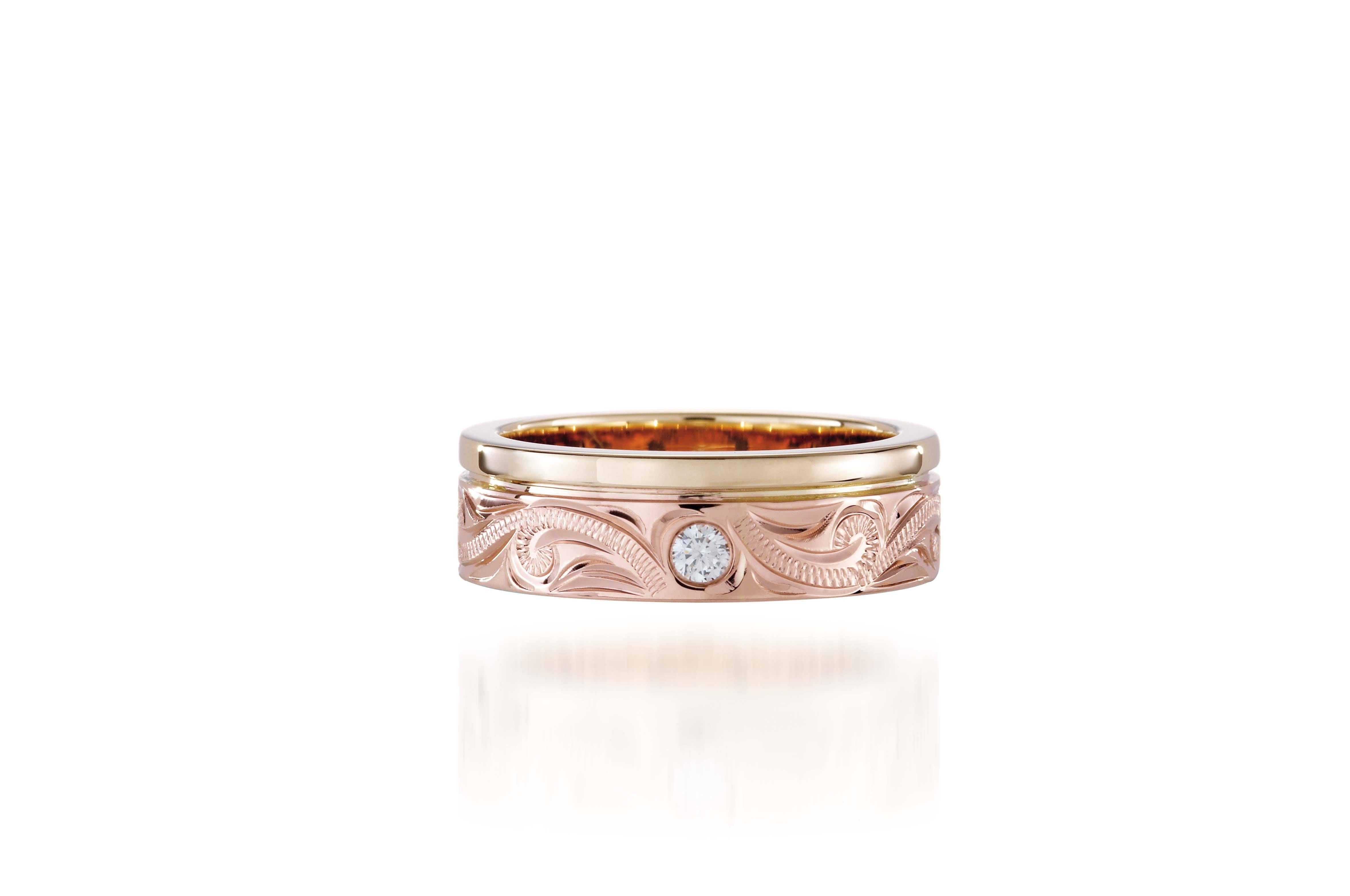 The picture shows a 14K yellow and rose gold two-tone wave channel 6mm ring with a diamond and hand-engravings.