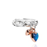 The picture shows a 14K rose gold and 925 sterling silver two-tone heart ring with hand engravings and opal.
