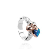 The picture shows a 14K rose gold and 925 sterling silver two-tone heart ring with hand engravings and opal.