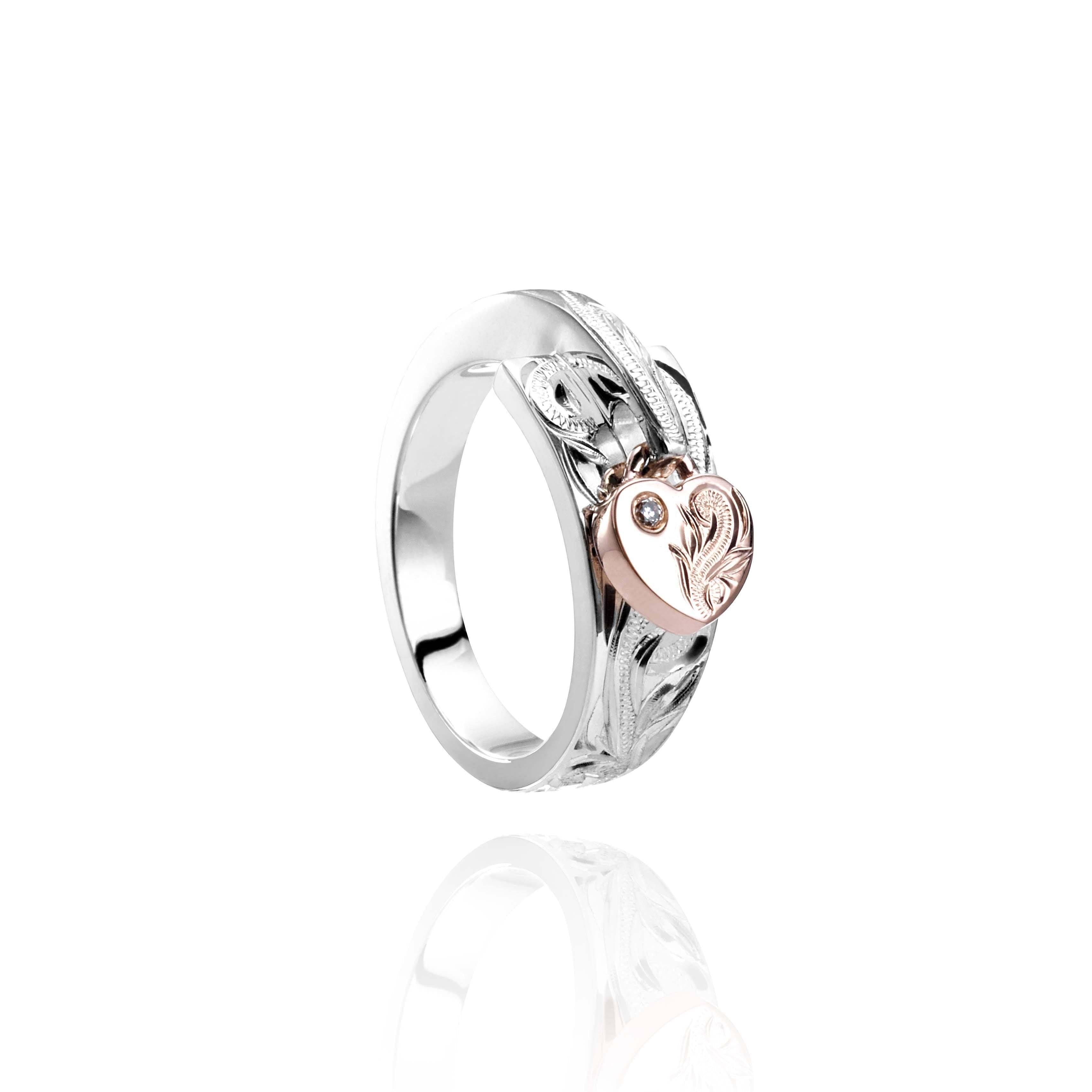 The picture shows a 14K rose gold and 925 sterling silver two-tone heart wrap ring with hand-engravings and a diamond.