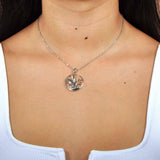 A model wearing the Sterling silver pendant designed to look like a Nene bird flying featuring Abalone.