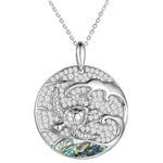 Sterling silver medallion pendant with a turtle swimming away from the abalone tides.