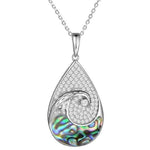 Sterling silver tear drop pendant with and abalone wave against the topaz sky.