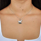 A model wearing a Sterling Silver Nene pendant featuring the bird stood on abalone.