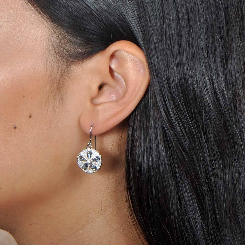 Abalone Pavé Sand Dollar Hook Earrings Earrings Island by Koa Nani Abalone, Sterling silver, and pave sand dollar earrings worn by a model.