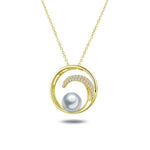 In this photo there is a yellow gold circle pendant with a wave, diamonds, and one white Akoya pearl.
