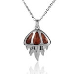 In this photo there is a sterling silver and koa wood jellyfish pendant.
