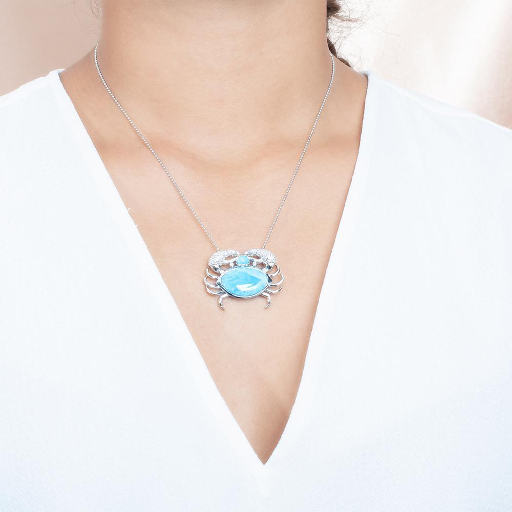 The picture shows a model wearing a 925 sterling silver larimar blue crab treasure pendant.