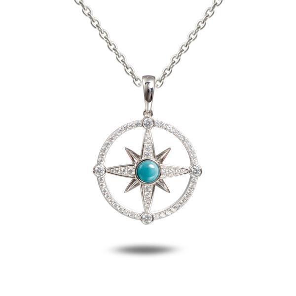 In this photo there is a sterling silver compass pendant with blue larimar and topaz gemstones.