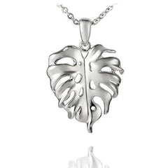 In this photo there is a sterling silver monstera pendant.