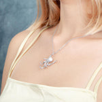 The picture shows a model wearing a 925 sterling silver octopus pendant with topaz.