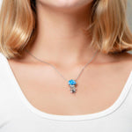 The picture shows a model wearing a 925 sterling silver opalite button jellyfish pendant.