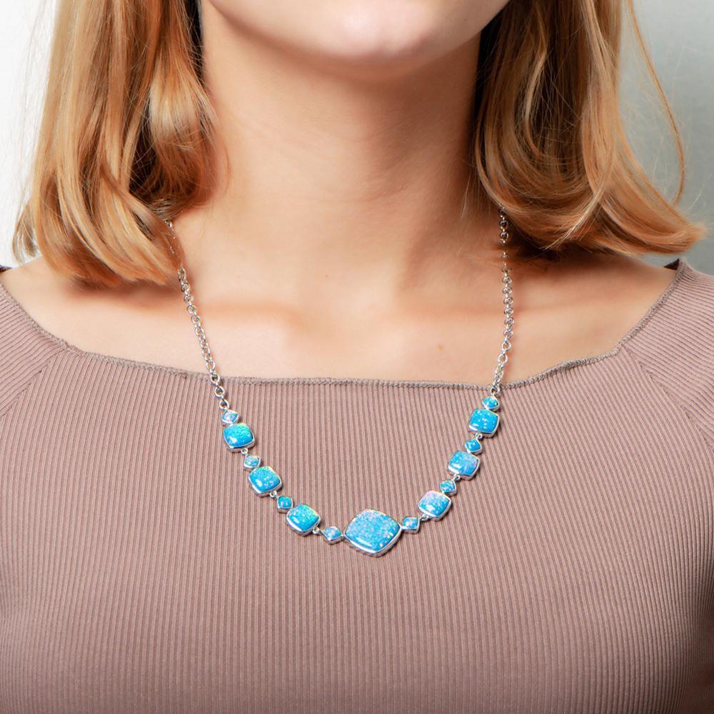 The picture shows a model wearing a 925 sterling silver opalite cushion cut necklace.