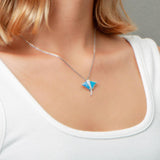 The picture shows a model wearing a 925 sterling silver opalite eagle ray pendant with cubic zirconia.