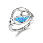 The picture shows a 925 sterling silver opalite whale tail in a wave ring with topaz.