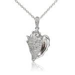 In this photo there is a sterling silver king conch shell pendant with topaz gemstones.