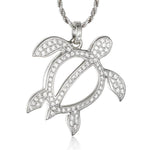 In this photo there is a white gold sea turtle pendant with topaz gemstones.