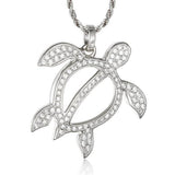 In this photo there is a white gold sea turtle pendant with topaz gemstones.