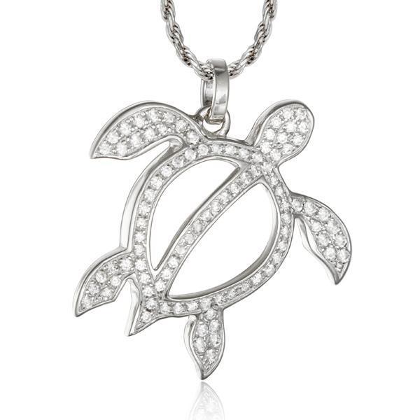 In this photo there is a white gold sea turtle pendant with topaz gemstones.
