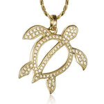 In this photo there is a yellow gold sea turtle pendant with topaz gemstones.