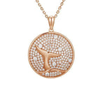 The picture shows a 925 sterling silver, rose gold vermeil, pavé whale tail medallion pendant with topaz.