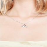 The picture shows a model wearing a 925 sterling silver whale tail pendant.