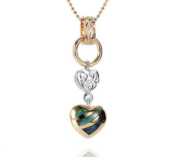 This picture shows a 14K yellow and white gold charm pendant featuring a heart motif paired with opal.