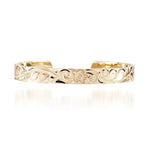 The picture shows a 14K yellow gold bangle featuring a sea turtle engraving.