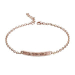 The picture shows a 14K rose gold bar bracelet with diamonds and whale engraving.