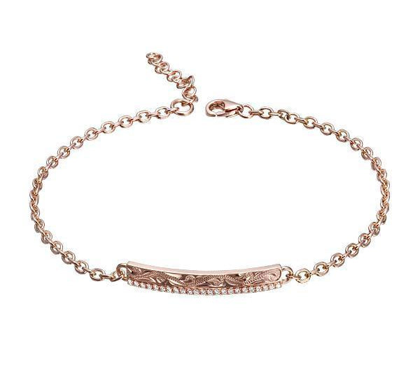 The picture shows a 14K rose gold bar bracelet with diamonds and whale engraving.