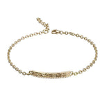 The picture shows a 14K yellow gold bar bracelet with diamonds and whale engraving.