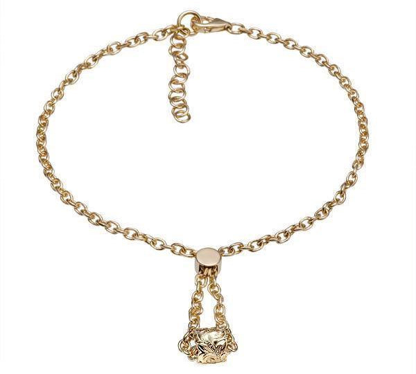 The picture shows a 14K yellow gold barrel bracelet with scroll engraving.
