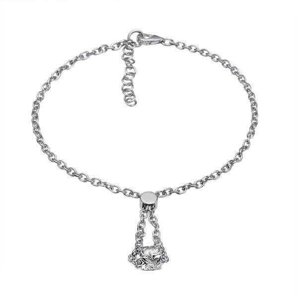 The picture shows a 14K white gold barrel bracelet with scroll engraving.
