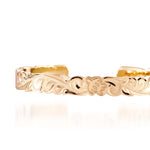 The picture shows a 14K yellow gold hand-engraved bangle sea turtle design with cut-out edges.
