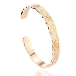 The picture shows a 14K yellow gold hand-engraved bangle sea turtle design with cut-out edges.
