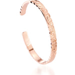 The picture shows a 14K rose gold cut-out bangle with plumeria engraving.