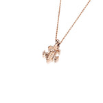 The picture shows a 14K yellow gold fleur-de-lis pendant with hand engravings.